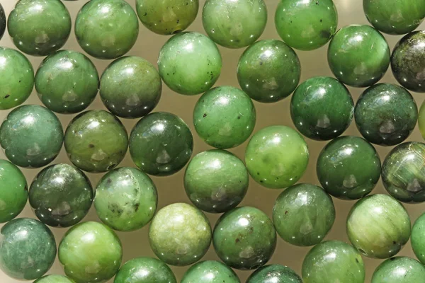 Natural green jade nephrite mineral stones beads. Green and gras