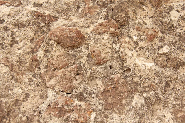Hintergrund aus braunen, beigen und grauen Steinen. die alte mauer von ston — Stockfoto