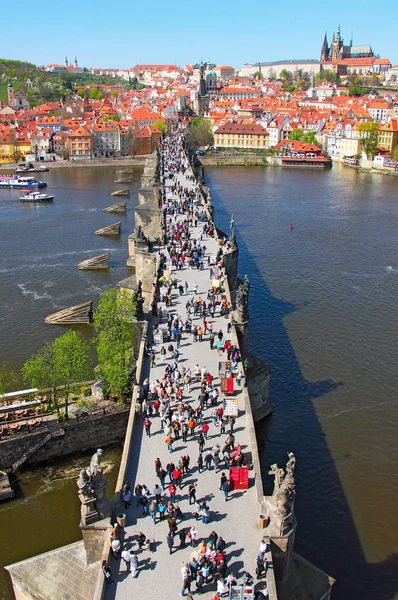 Praagse Karelsbrug over de rivier de Moldau en veel mensen, pan — Stockfoto