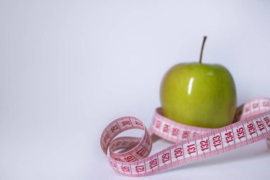 Yeşil elma yerine kırmızı şerit. Diyet ve sağlıklı yaşam, kilo verme konsepti. Üst Manzara. Uzayı kopyala İzole edilmiş. Beyaz arkaplan