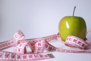 Yeşil elma yerine kırmızı şerit. Diyet ve sağlıklı yaşam, kilo verme konsepti. Üst Manzara. Uzayı kopyala İzole edilmiş. Beyaz arkaplan