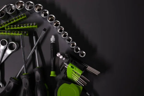 A set of building tools and instruments for repair in black and green colour. Must-have for men. Equipment for building. Repair tool kit. construction concept. gray background