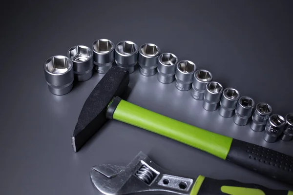 A set of building tools and instruments for repair in black and green colour. Must-have for men. Equipment for building. Repair tool kit. construction concept. gray background