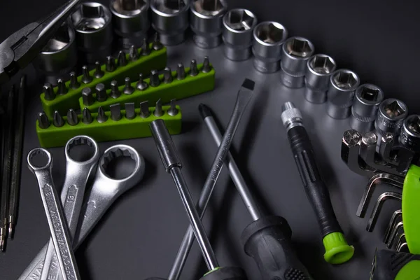 A set of building tools and instruments for repair in black and green colour. Must-have for men. Equipment for building. Repair tool kit. construction concept. gray background