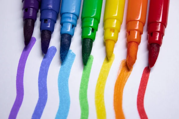 a bunch of colored markers laid out in rainbow order. stationery concept. copy space. isolated