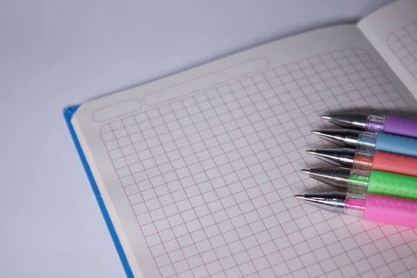 Blauw notitieboekje met een kleurrijke pennen erop. briefpapier concept. kopieer ruimte. geïsoleerd — Stockfoto
