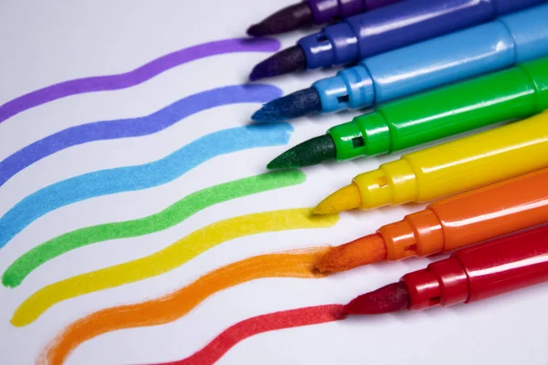 a bunch of colored markers laid out in rainbow order. stationery concept. copy space. isolated