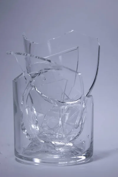 fragments of a broken glass in a broken glass on a white background. Isolated. Copy space