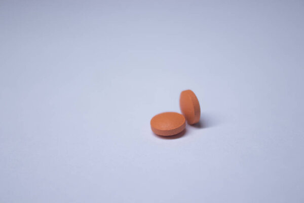 orange tablet - pill on a white background. medicine and disease concept. Isolated