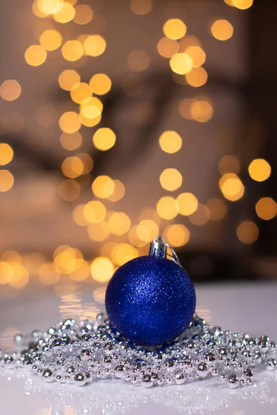 Blue Christmas ball toy on a background of golden bokeh. new year theme — Stock Photo, Image