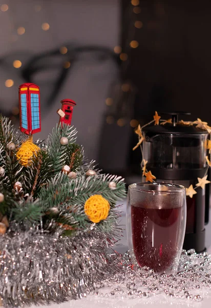 French press and tea in double-bottom glass near New Years decorations. Christmas theme — Stock Photo, Image