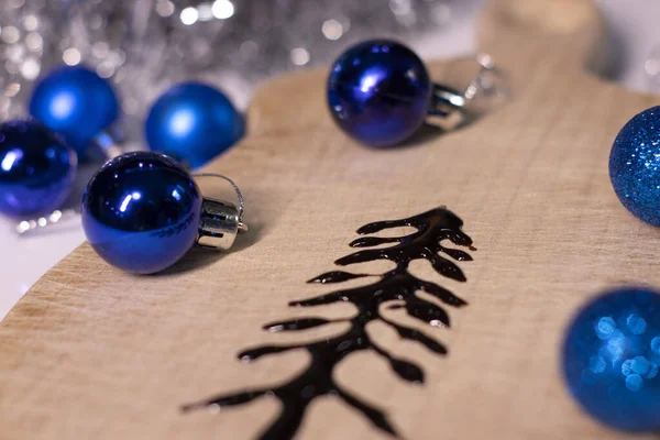 在新年装饰品旁边的木板上用巧克力做成的圣诞树 — 图库照片