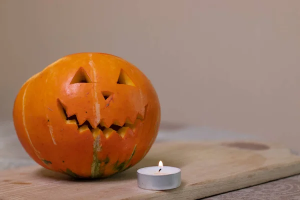 the process of making a Halloween pumpkin. lighted candle. horror theme and Halloween