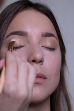 Güzel bir esmerin makyajını yapma süreci. güzellik, modellik ve kozmetik konsepti