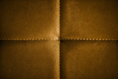 Bal dijon renginde yapay deri dikilmiş. Kanepe yüzeyine yakın çekim. Doğrudan yukarıdan bak. Dört eşit parçaya bölünmüş büyük kopya alanı ile desenli yatay arkaplan.