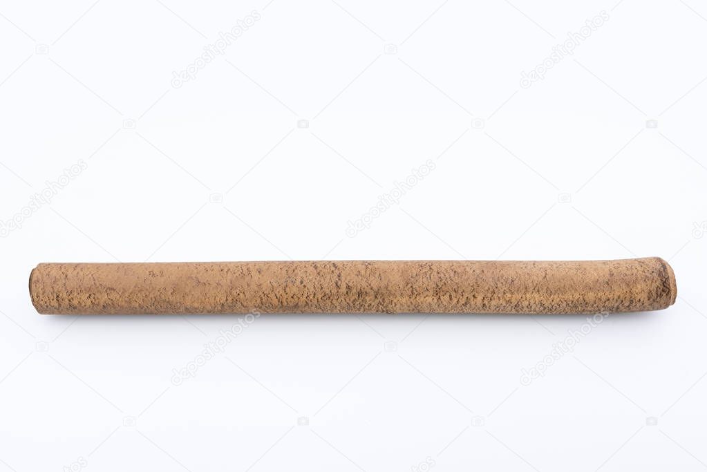 Ebonite stick on white background, with shadows. Also is known as hard rubber or vulcanite