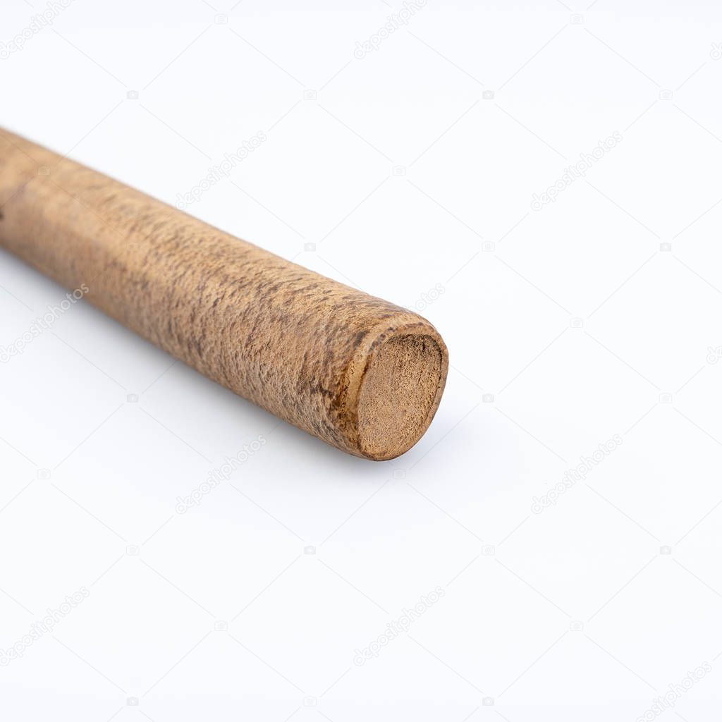 Ebonite stick on white background, with shadows. Also is known as hard rubber or vulcanite