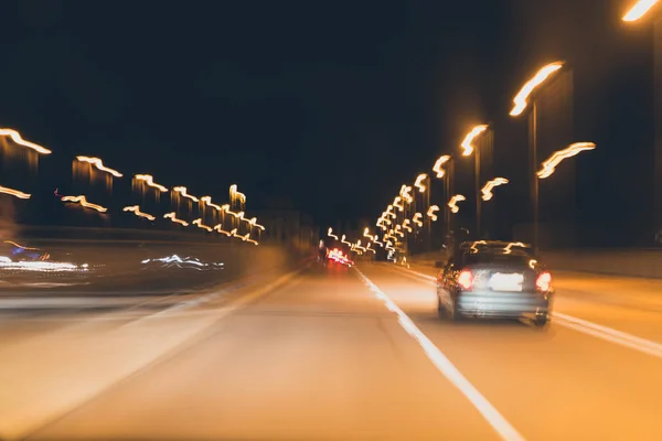 Abstract background - speed and lights, cars on the night road, matte toning effect