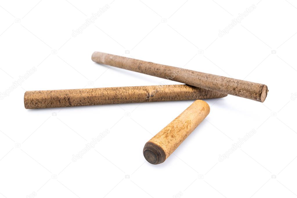 Ebonite stick on white background, with shadows. Also is known as hard rubber or vulcanite. Serves as a material for making decoration or other products