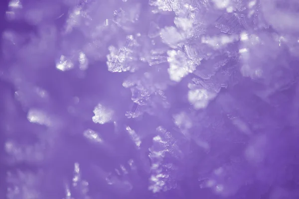 Abstract winter background with violet toning. Crystals of snow cover, macro — Stock Photo, Image