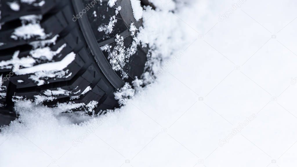 Wheel in the snow, close up. Reliable winter tires - the passengers safety