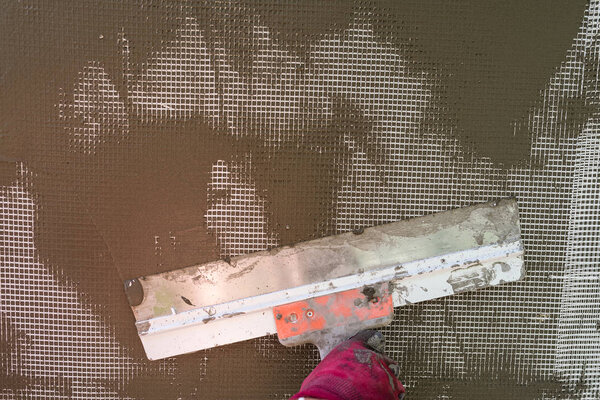 Plastering the wall with a spatula, working process