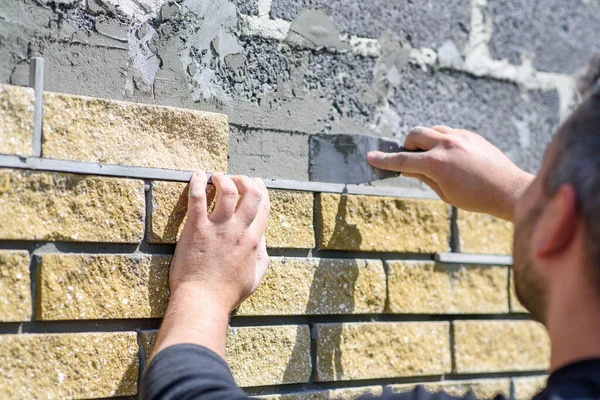 Man Decorates Facade Fence Decorative Torn Bricks Close View Work — Stock Photo, Image