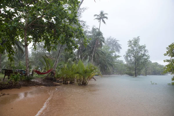 Heavy tropical rain and flooding on the beach