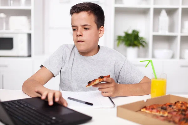 Young Teenager Boy Working Project Having Bite Pizza Kitchen Desk — Stock Photo, Image