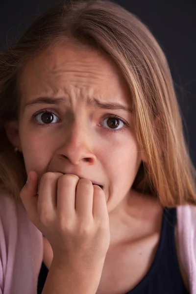 Worried teenager girl bite her nails - close up portrait — Stock Photo, Image
