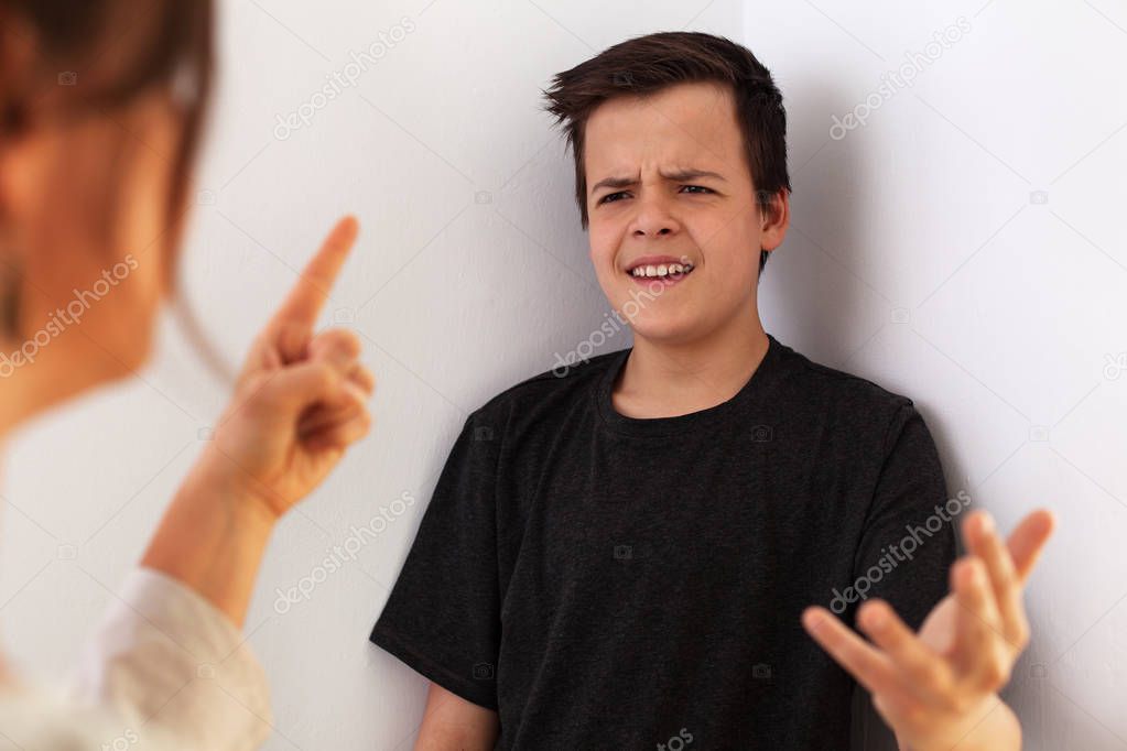 Woman having a fight with her teenager son - gesturing and expre