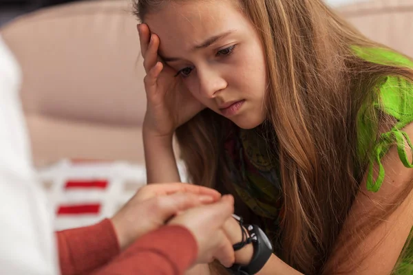 Sad teenager girl at counseling - woman professional hands holdi — Stock Photo, Image