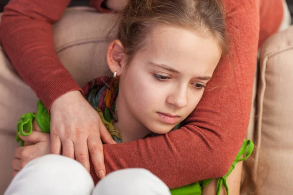 Mother holding sad teenager girl from behind - close up — Stock Photo, Image