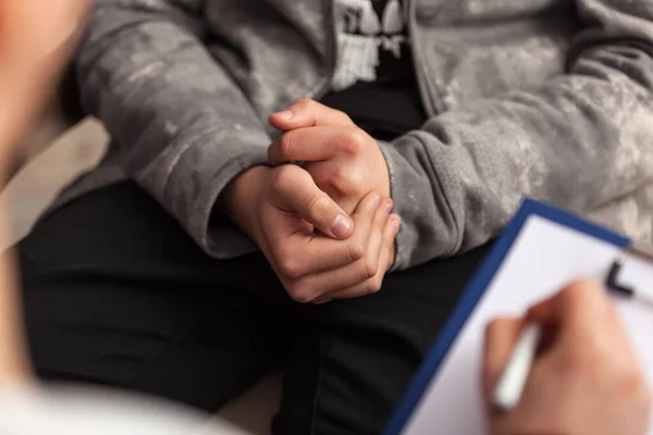 Young teenager boy at counseling - close up on hands — Stock Photo, Image