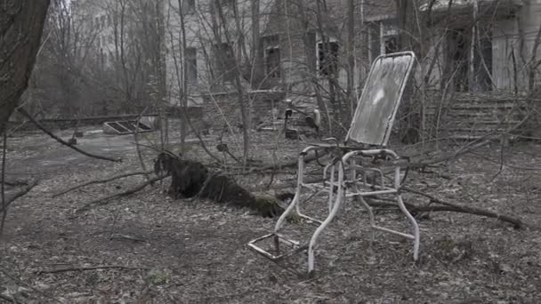 Horreur de Tchernobyl. Chaise médicale devant l'hôpital détruit — Video