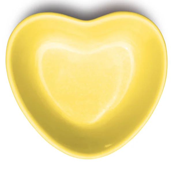 Gelber Teller in Herzform isoliert auf weißem Hintergrund. — Stockfoto