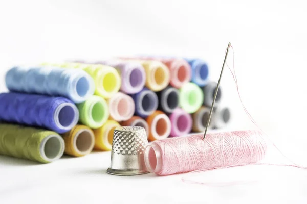 Needle,thimble and colorful spools of thread — Stock Photo, Image