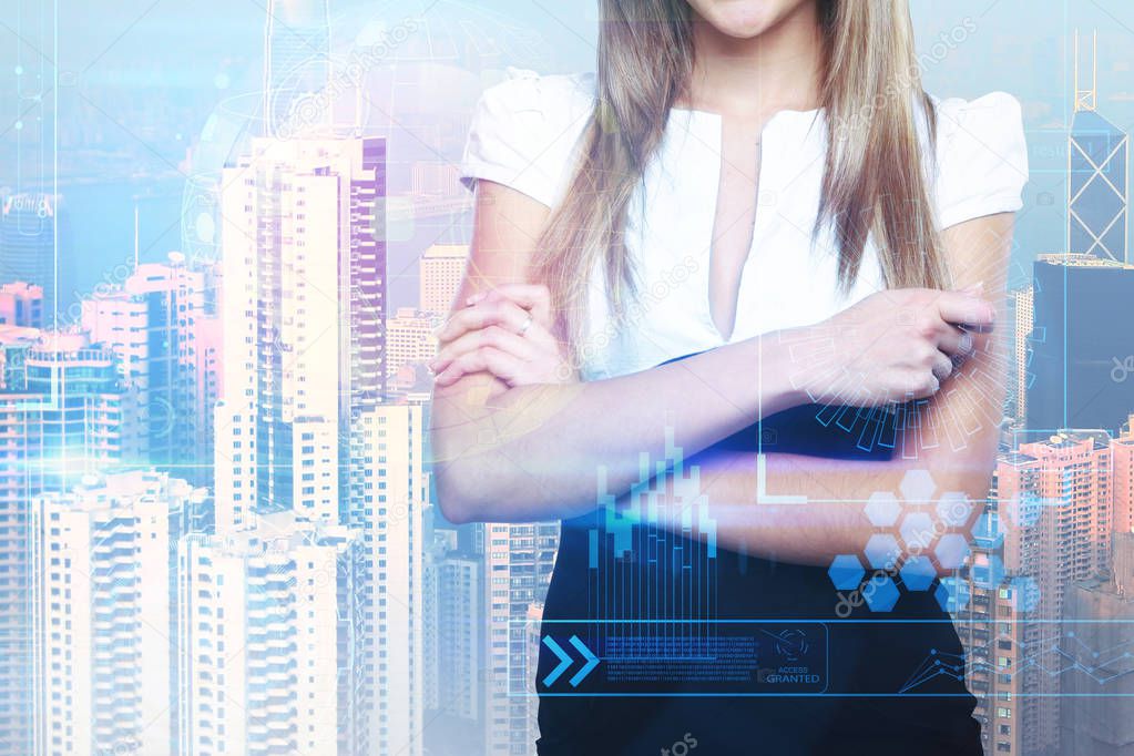 Businesswoman with folded arms standing on bright city background with business interface. Network and future concept. Double exposure 