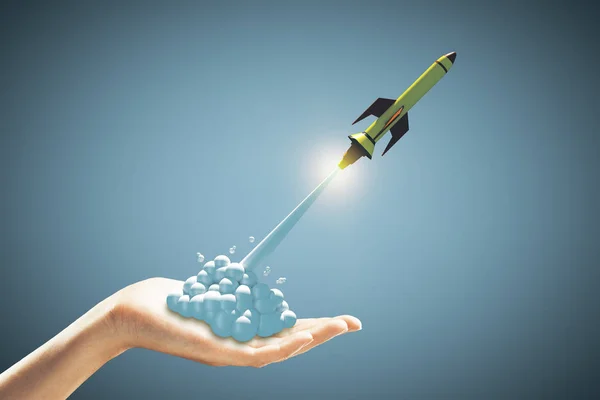 Startup Concept Green Rocket Flying Out Human Hand Blue Background — Stock Photo, Image