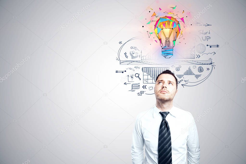 business idea concept with young businessman looking at colorful 3d bulb illustration above the head and ideas sketch on white wall background