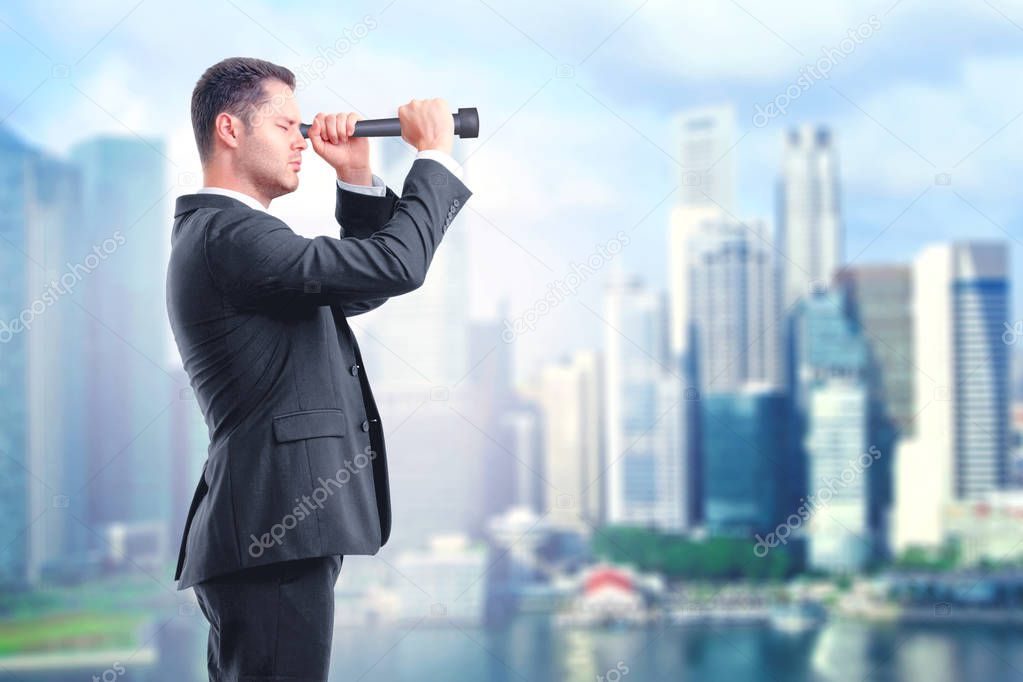 look into the future concept with businessman looking through a telescope at blured city background