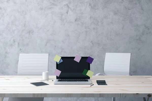 mockup black laptop monitor with post-it sticks on wooden table in office with concrete wall background. 3d rendering