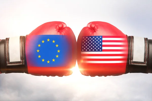 Red boxing gloves with country flags against each other on cloudy sky background. EU vs USA concept. 3D Rendering