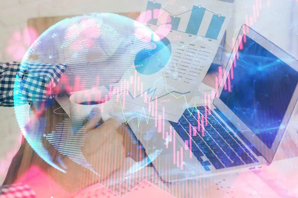 Double exposure of businessman working on laptop on background. International business hologram in front. Concept of success.