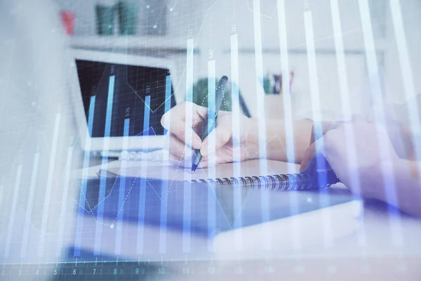 Financial graph displayed on womans hand taking notes background. Concept of research. Double exposure