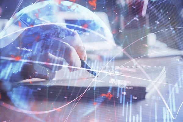 Financial charts displayed on womans hand taking notes background. Concept of research. Double exposure