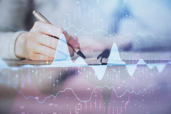 Hands writing information about stock market in notepad. Forex chart holograms in front. Concept of research. Multi exposure — Stock Photo, Image