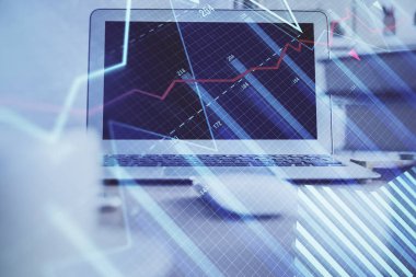 Finansal tablo çizimi ve arka planda bilgisayar olan bir tablo. Çoklu maruz kalma. Uluslararası pazarlar kavramı.