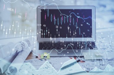 Finansal pazar grafiği hologramı ve kişisel bilgisayar arka planda. Çoklu maruz kalma. Önx kavramı.