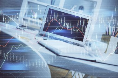 Finansal grafik renkli çizimler ve arka planda bilgisayar olan tablolar. Çifte maruziyet. Uluslararası pazarlar kavramı.